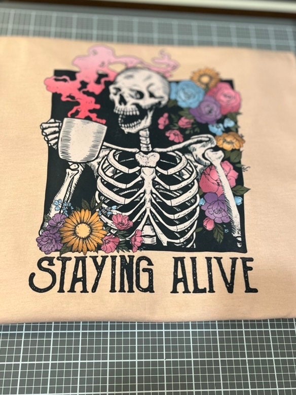 Staying Alive Floral Skeleton Drinking Coffee Tee / Coffee Skeleton T-Shirt - Stitch N Bling